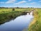 Drainage ditch with small pedestrian bridge