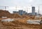 Drainage pipes at the large scale construction site against tower cranes.