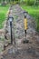 Drainage trench in farm yard and two shovels near grove