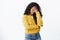 Drained and tired african-american woman in yellow sweater, making face palm gesture, close eyes sighing from hard