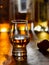 Dram of single malt scotch whisky and bottles on background