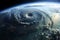 A dramatic aerial view of a hurricane swirling over the ocean, showing the massive storm system as it approaches a coastline,