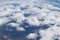 Dramatic aerial view image from aircraft of beautiful groups of white clouds with background of land underneath.Image use for