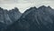 Dramatic alpine view of rocky mountains and cloudy sky, Dolomites