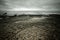 Dramatic Atlantic coast at low tide. Cracked stones tinted