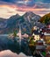 Dramatic autumn sunset on Hallstatt lake. Impressive evening viev of Hallstatt village, in Austria`s mountainous Salzkammergut