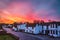 Dramatic and beautiful sunrise illuminating the sky over the quaint white cottages and terrace houses of Monkton, Kent, UK