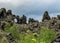 Dramatic black lava rock structures, unique volcanic flow formations and green Icelandic forest, Myvatn area, Northern Iceland, Eu