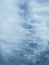 Dramatic blue sky with clouds. Spooky abstract background pattern texture.