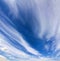 Dramatic blue sky with puffy white clouds in bright clear sunny