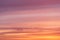Dramatic bright soft sunrise, sunset pink orange sky with clouds background texture