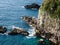 Dramatic cliffs and blue ocean waves at Cape Ashizuri, Shikoku`s southernmost point