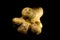 Dramatic closeup shot of an interesting-shaped potato on a black background.