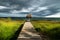 Dramatic clouds behind hut on a dock along the lake shore with dark blue cloudscape, El Remate, Peten, Guatemala