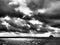 Dramatic clouds, black and white of offshore oil platform