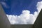 Dramatic clouds through a built structure`s open roof