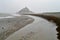 Dramatic clouds loom over Mont-Saint Michel at low tide