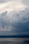 Dramatic clouds over lake and mountains at dusk