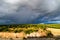 Dramatic clouds over the landscape of croatia with rain in the distance