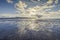 Dramatic clouds over sandy beach at low tide