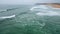 Dramatic cloudy seaside panorama aerial view. Foamy sea waves crashing at beach