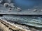 Dramatic cloudy sky over the lake, strong surf, darkened water, southern Urals