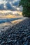 Dramatic coast with rocky volcanic beach, green tree, waves and amazing sunset, Limbe, Cameroon