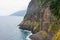 Dramatic coastal scenery old coastal road madeira with waterfall steep cliffs