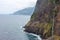 Dramatic coastal scenery old coastal road madeira with waterfall steep cliffs