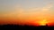 Dramatic colorful red fiery sunset timelapse sky landscape with line row of city buildings silhouette . Natural