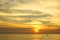 Dramatic colorful sea sunset with sun setting on water lonely boat on horison