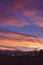 A dramatic and colourful Sunset over the Farmland and trees of the rural community of Colliston