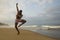 Dramatic contemporary dance choreographer doing ballet beach workout, young attractive and athletic afro black American man