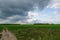 Dramatic countryside landscape with thunderclouds in the sky over a wheat field