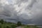 Dramatic countryside landscape with thunderclouds in the sky over a wheat field