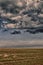 Dramatic dark clouds over the agriculture field in the summer. Horizon, relaxing mystiqu