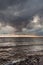 Dramatic dark clouds during sunset at sea