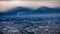 Dramatic and dark process cityscape in strom and smog layer mountain background in japan