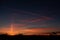 dramatic dark red clouds in sunset over countryside fields and forests