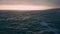 Dramatic deep dark ocean surface rippling. Drone shot gray sky over stormy sea.