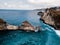 Dramatic drone shot of beautiful cliffs in Indonesia with blue ocean.