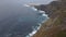 Dramatic establishing shot of waves raging on the cliffs