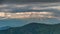 Dramatic evening thunder clouds sky over mountains time lapse