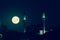 Dramatic full moon over Izmir skyline at night with mosque silhouette