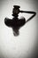 Dramatic Gavel Silhouette on Reflective Wood