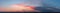 Dramatic gloomy panorama of bright saturated sunset with dark clouds