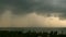 Dramatic gloomy sky with dark thunderstorm clouds over turquoise sea. Hurricane on ocean horizon. Vivid aerial timelapse