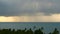 Dramatic gloomy sky with dark thunderstorm clouds over turquoise sea. Hurricane on ocean horizon. Vivid aerial timelapse