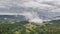 Dramatic grey clouds over green forest landscape aerial