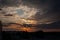 dramatic high contrast clouds in sunset over seaside beach